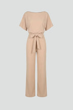 Beige batwing-sleeve jumpsuit with tie belt and wide straight legs, shown on a plain background
