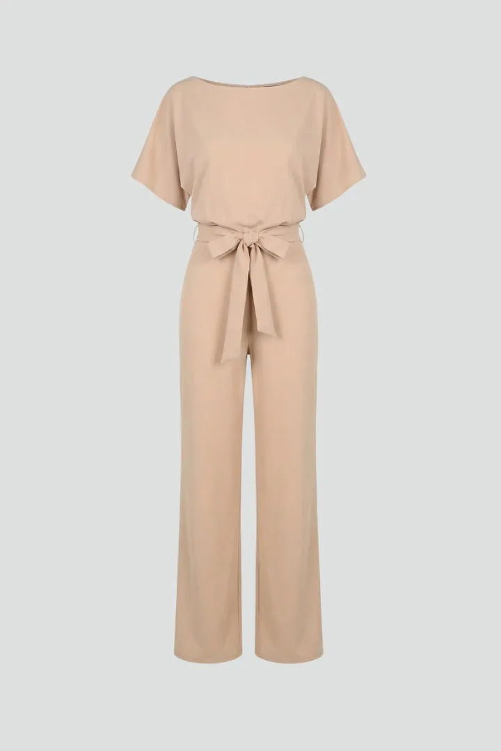 Beige batwing-sleeve jumpsuit with tie belt and wide straight legs, shown on a plain background