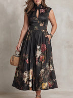 Close crop of the dress bodice and flowing pleated skirt, highlighting the sleeveless cut and A-line silhouette