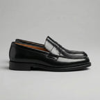 Side view highlighting the smooth upper, stacked heel and flexible rubber sole unit