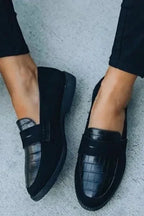 Side profile of the slip-on loafers showing the suede heel panel and croc-textured leather toe cap.