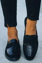 Front-on view of both loafers together, highlighting the penny strap detail and round toe shape.