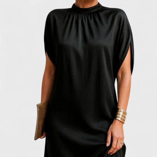 Close-up front view of the black mock-neck dress showing the ruched neckline detail and relaxed draped bodice