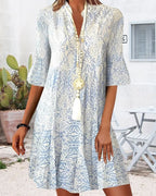 Three-quarter angle of the paisley print midi dress highlighting the bell sleeve and V-neckline detail