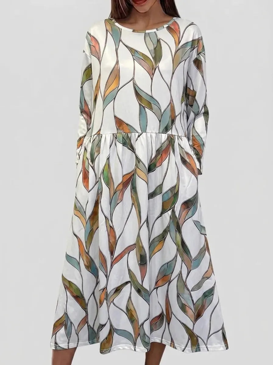 Front view of midi dress in an abstract multicoloured stained-glass leaf print on a white background