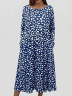Front view of navy blue midi dress with an allover white petal and floral print