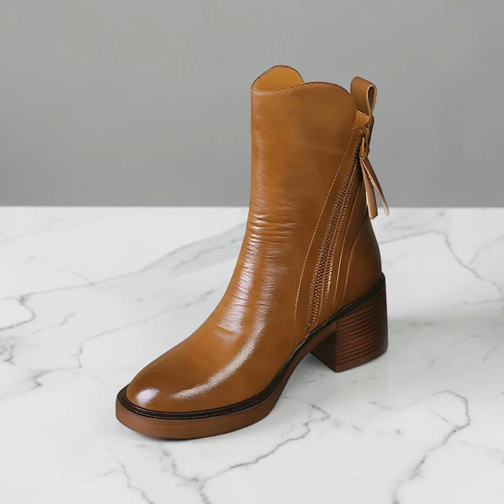 Side view of camel leather ankle boot showing glossy finish, side zip, and stacked block heel with platform sole