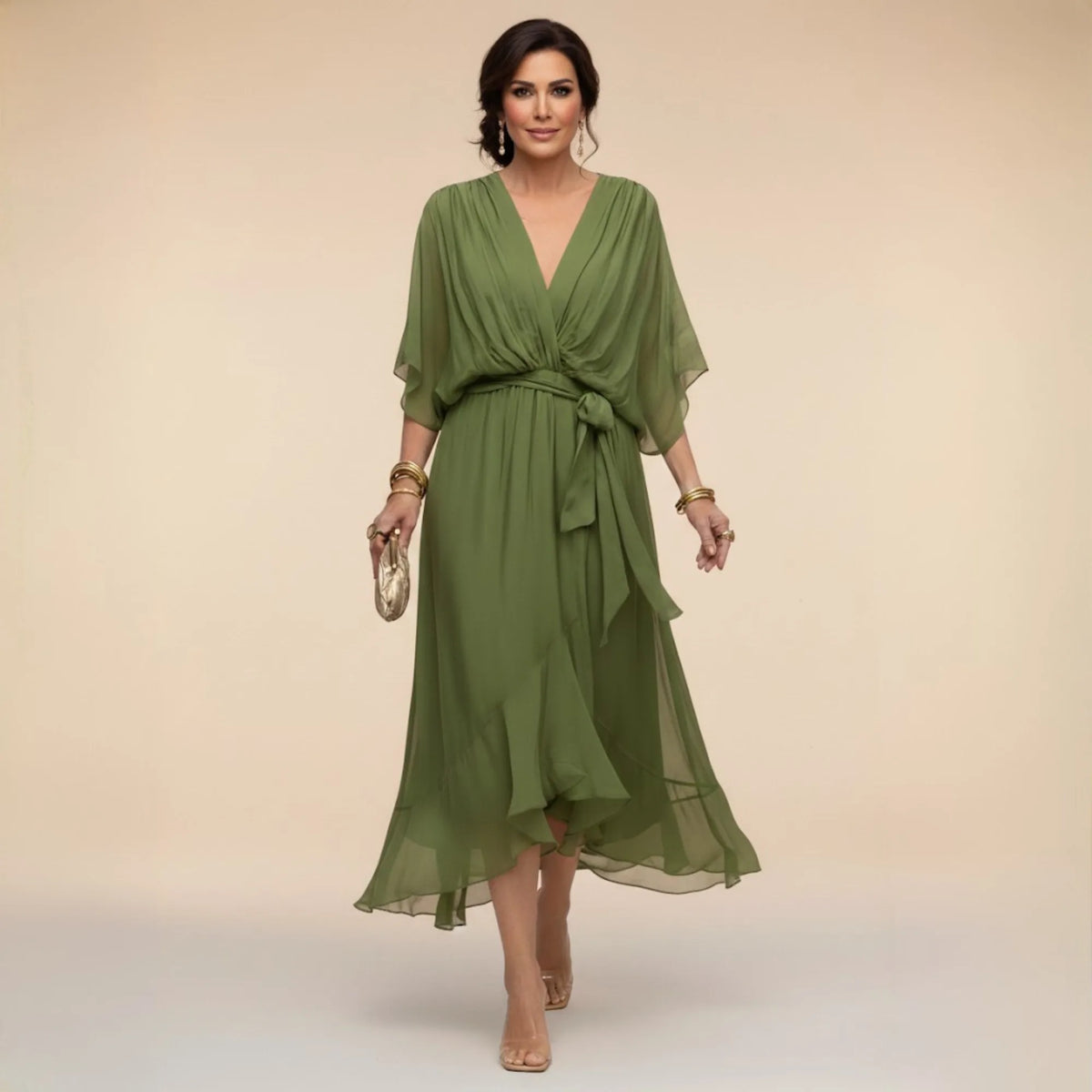 Woman modelling a green chiffon midi dress with V-neck, draped sleeves and tied waist belt