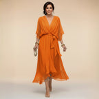 Full-length view of the flowing chiffon midi dress capturing the asymmetric handkerchief hemline