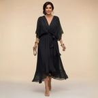 Front view of a black chiffon wrap-style midi dress with flowing kimono sleeves and belted waist