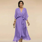 Lavender chiffon midi dress on model, highlighting the flutter sleeves and sash belt detail