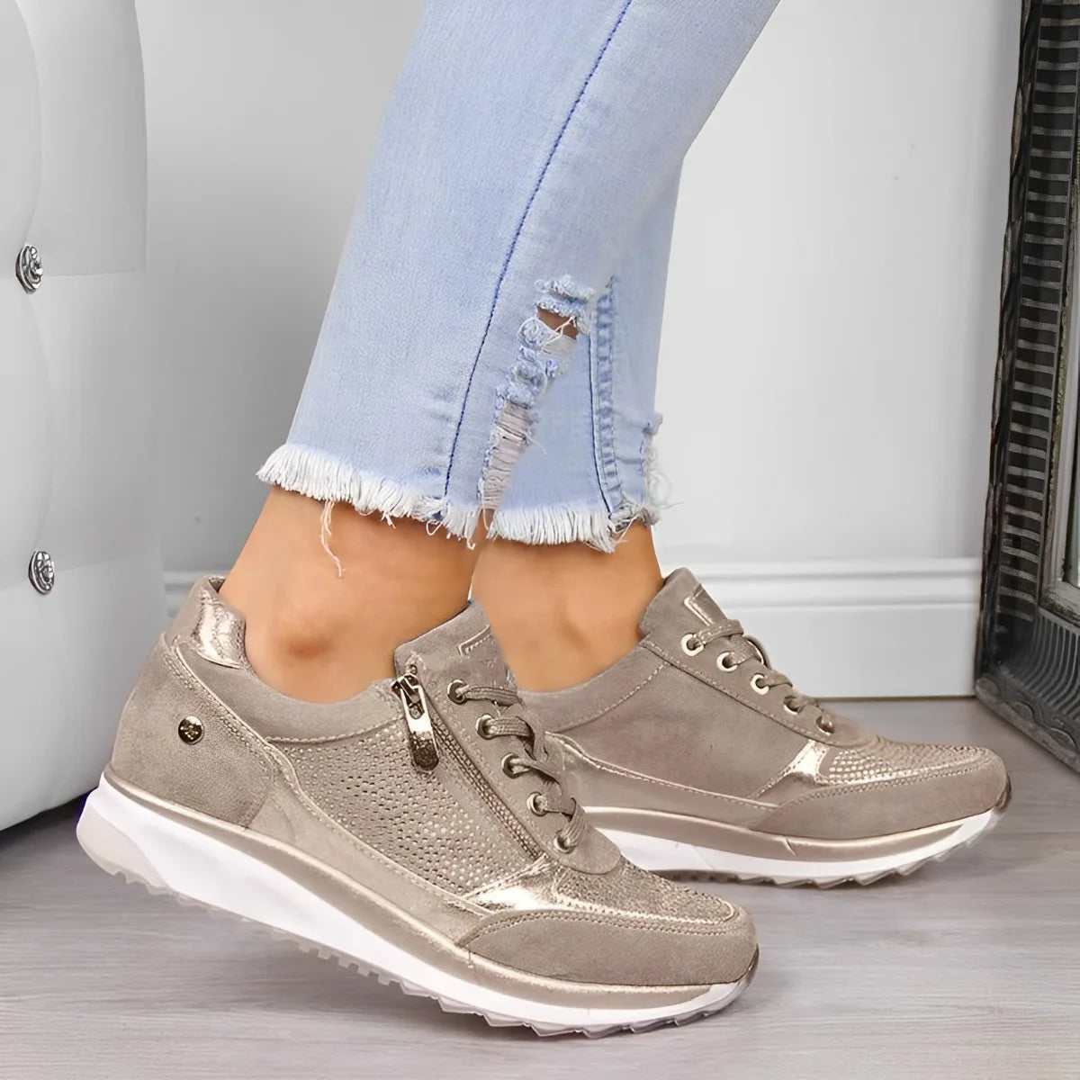 Close-up of olive green suede sneakers with metallic trim and zip detail worn with light wash jeans