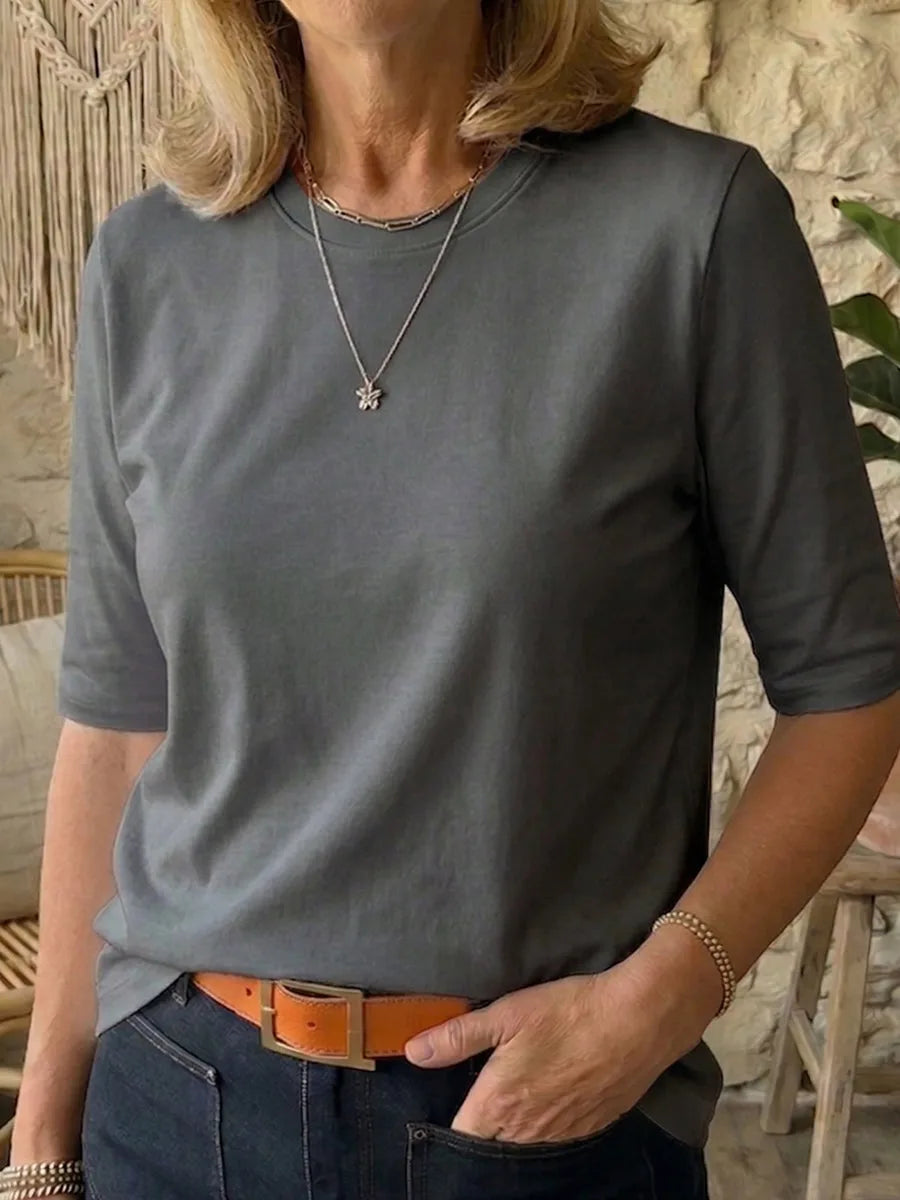 Charcoal grey half-sleeve t-shirt with a relaxed crew neckline, paired with a silver necklace