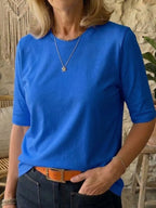 Royal blue half-sleeve cotton t-shirt worn with jeans and an orange leather belt, front close-up