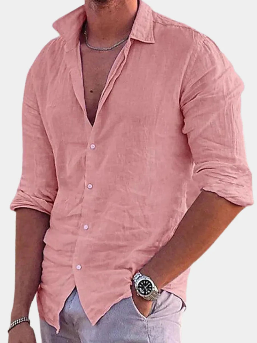 Close-up front view of a man in a pink cotton linen shirt, unbuttoned collar, with a chain necklace and watch