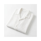 Shirt folded flat, showing the all-over crinkle texture and natural drape of the fabric