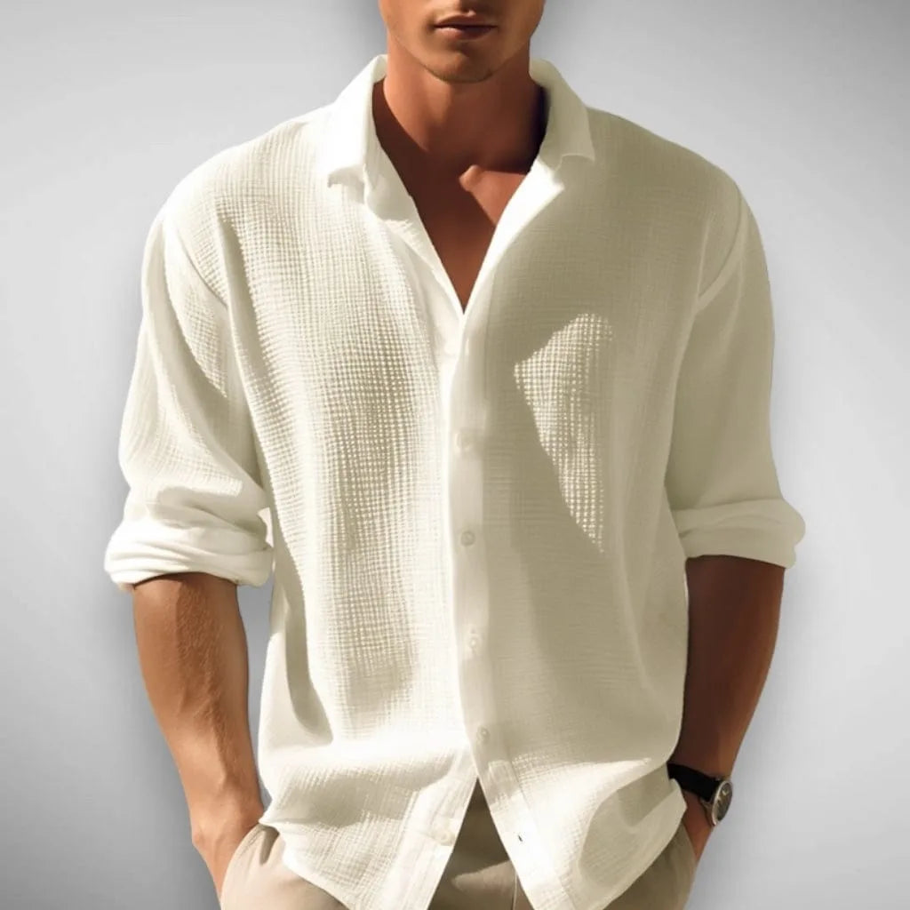Close-up front view showing the textured weave and relaxed fit of the white button-up shirt
