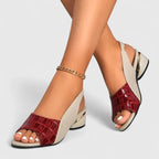 Red croc-embossed leather slingback sandals with cream side panel, open toe and sculpted gold-accented heel, shown on bare feet.