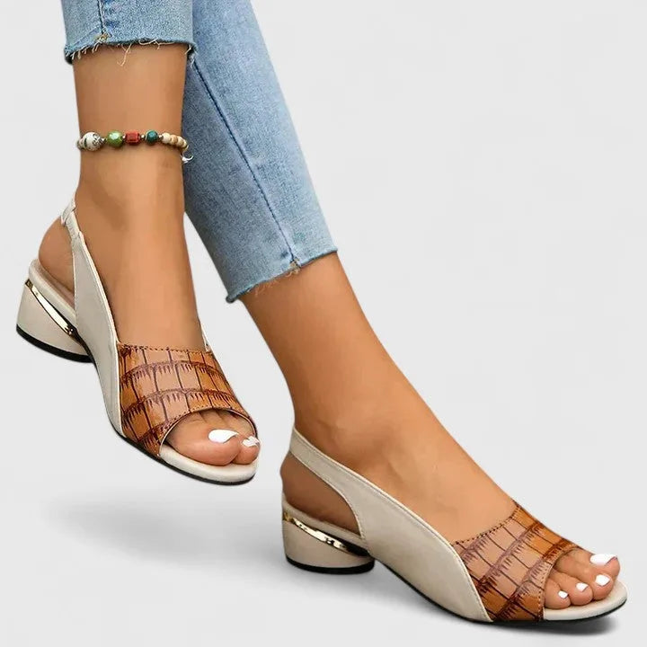 Brown woven-texture leather slingback sandals with cream panel and gold-trimmed heel, styled with cropped jeans and a beaded anklet.