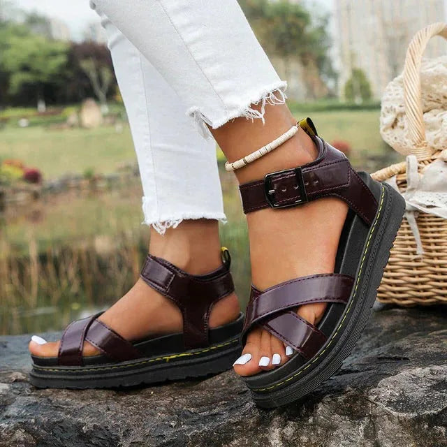 Burgundy leather-look platform sandal with crossover front straps and buckled ankle strap, styled with jeans