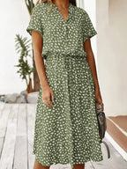 Close-up front view of the olive green dotted midi dress showing the button placket and collar detail