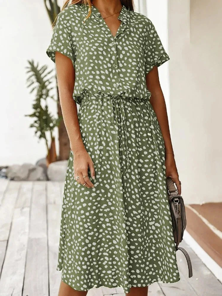 Close-up front view of the olive green dotted midi dress showing the button placket and collar detail