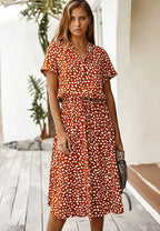 Front view of the rust orange dotted midi dress with collar, button placket and short sleeves