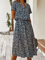 Side view of the rust orange dotted midi dress showing the A-line skirt and relaxed silhouette