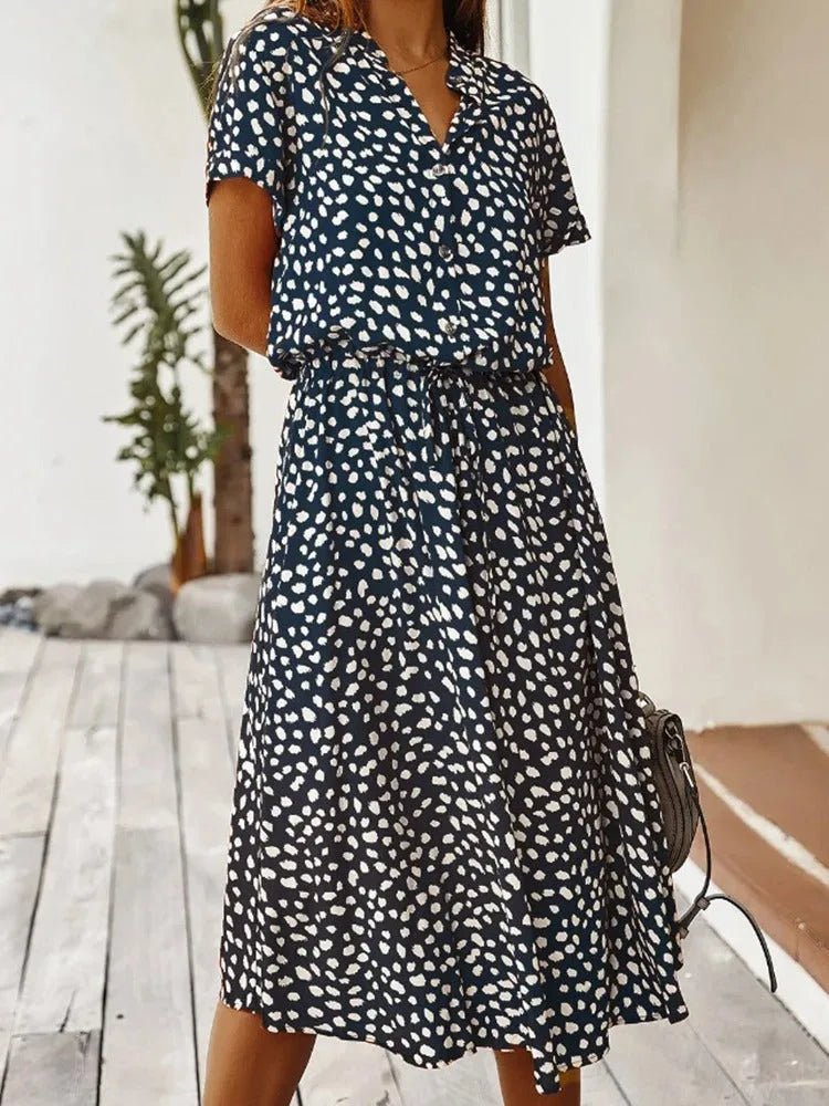 Side view of the rust orange dotted midi dress showing the A-line skirt and relaxed silhouette
