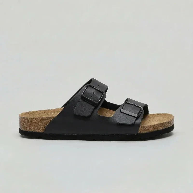 Side view of a black double-strap buckle sandal with matte strap finish and black outsole