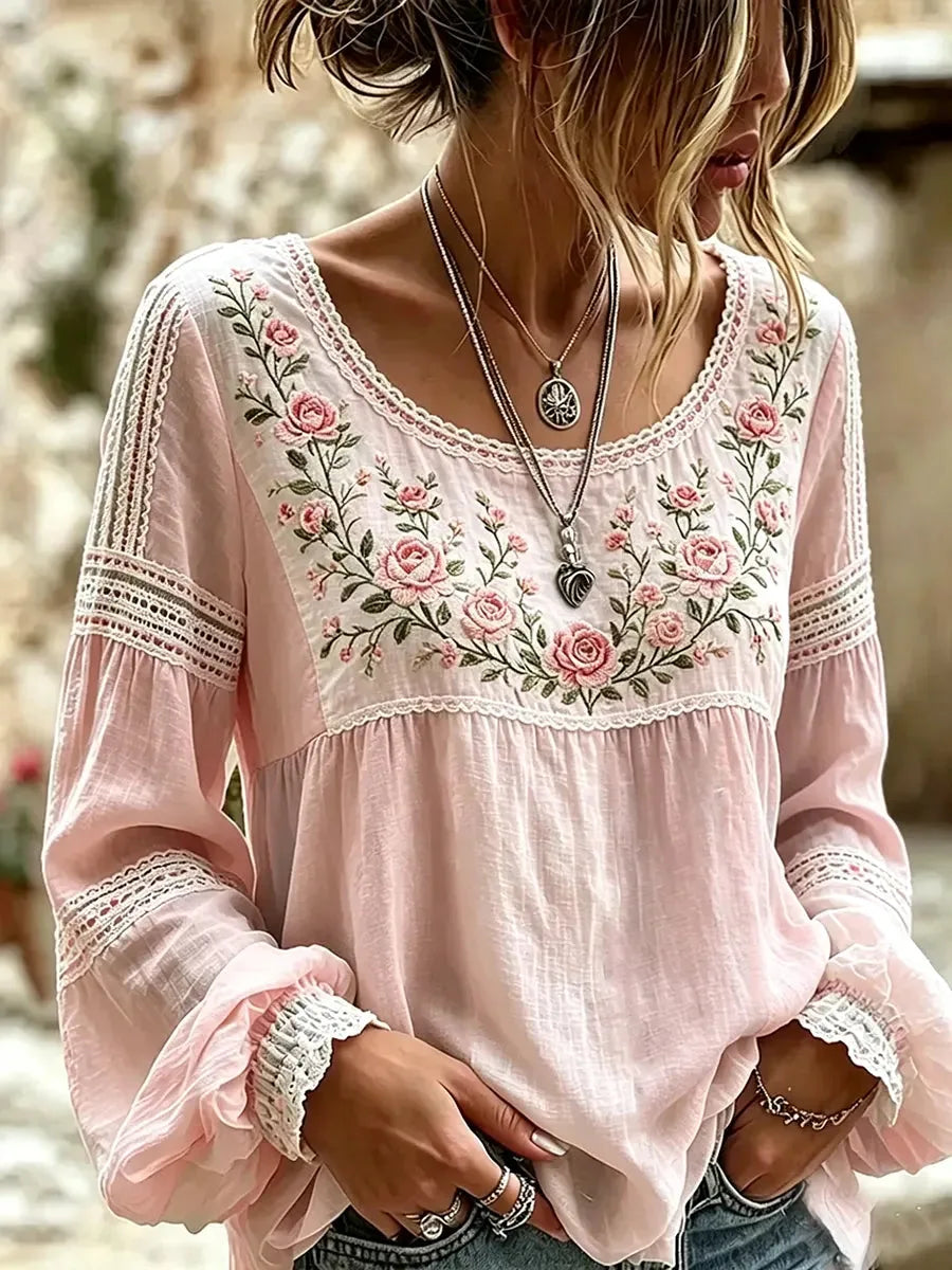 Soft pink linen-look blouse with scalloped lace trim and embroidered rose vine detail on the bodice