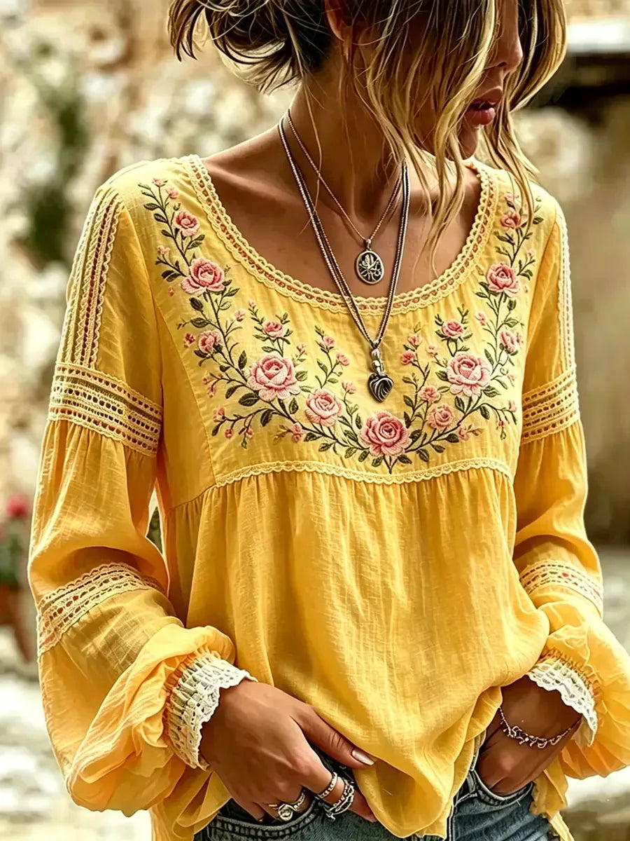 Yellow blouse with crochet lace detailing on the sleeves and an embroidered pink rose bouquet design