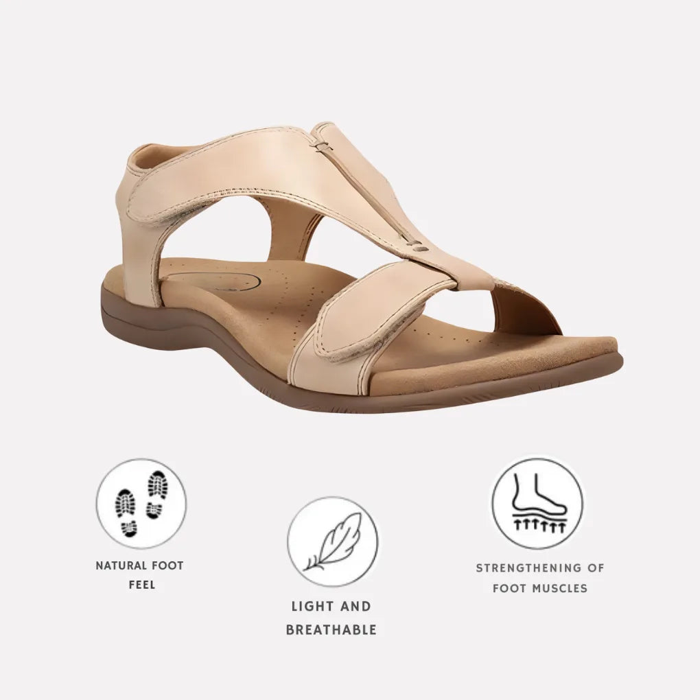 Beige leather T-strap sandal with soft padded footbed and brown outsole, side profile