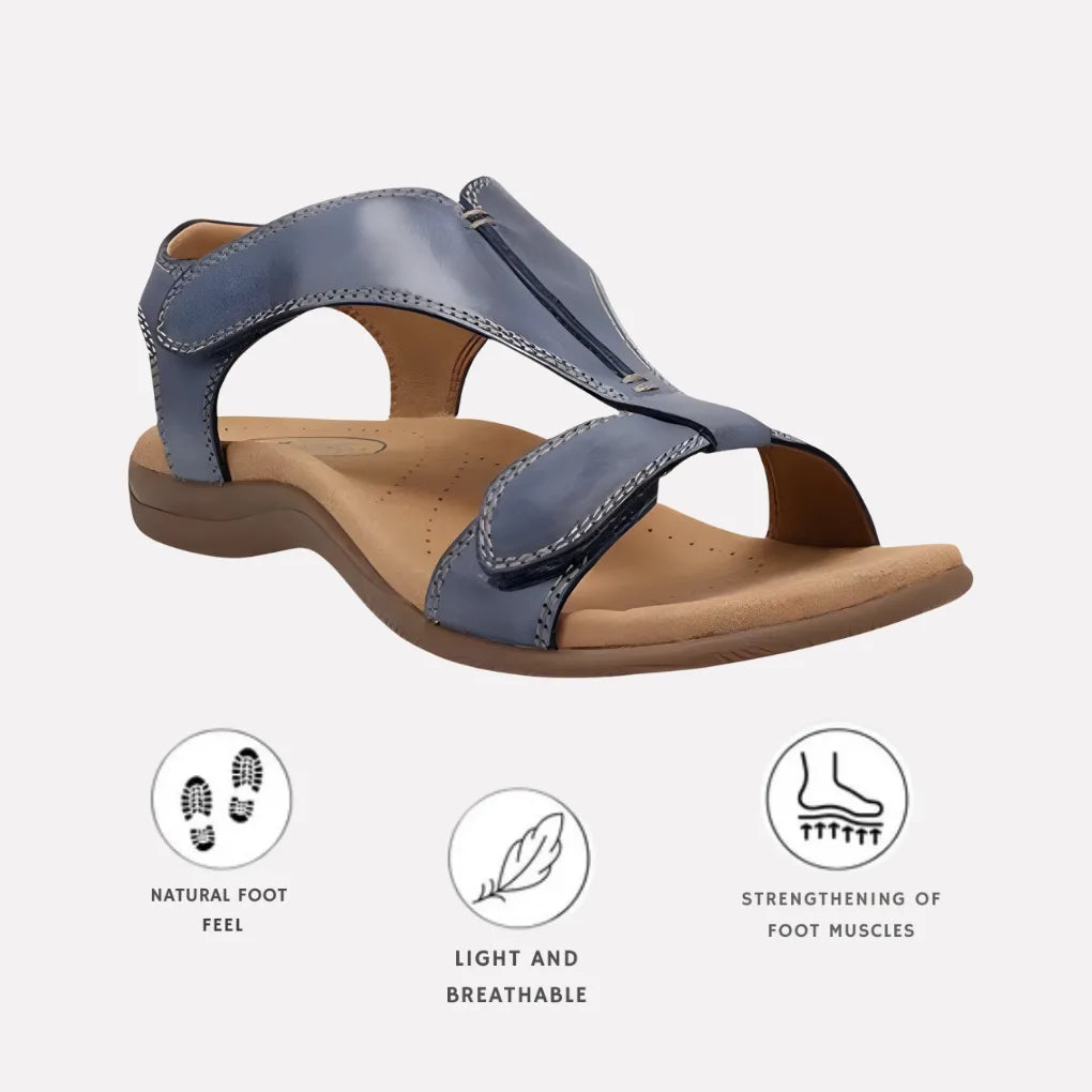 Marine blue leather T-strap sandal with adjustable hook-and-loop straps, angled side view