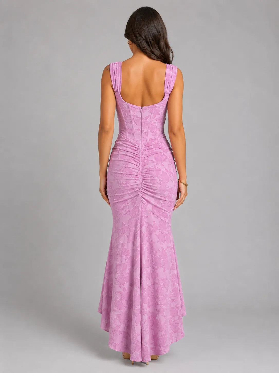 Back view of the pink corset maxi dress showing exposed back, centre zip and ruched seam detail