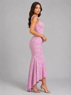 Side profile of the pink maxi dress highlighting the structured bodice and flowing asymmetric hemline