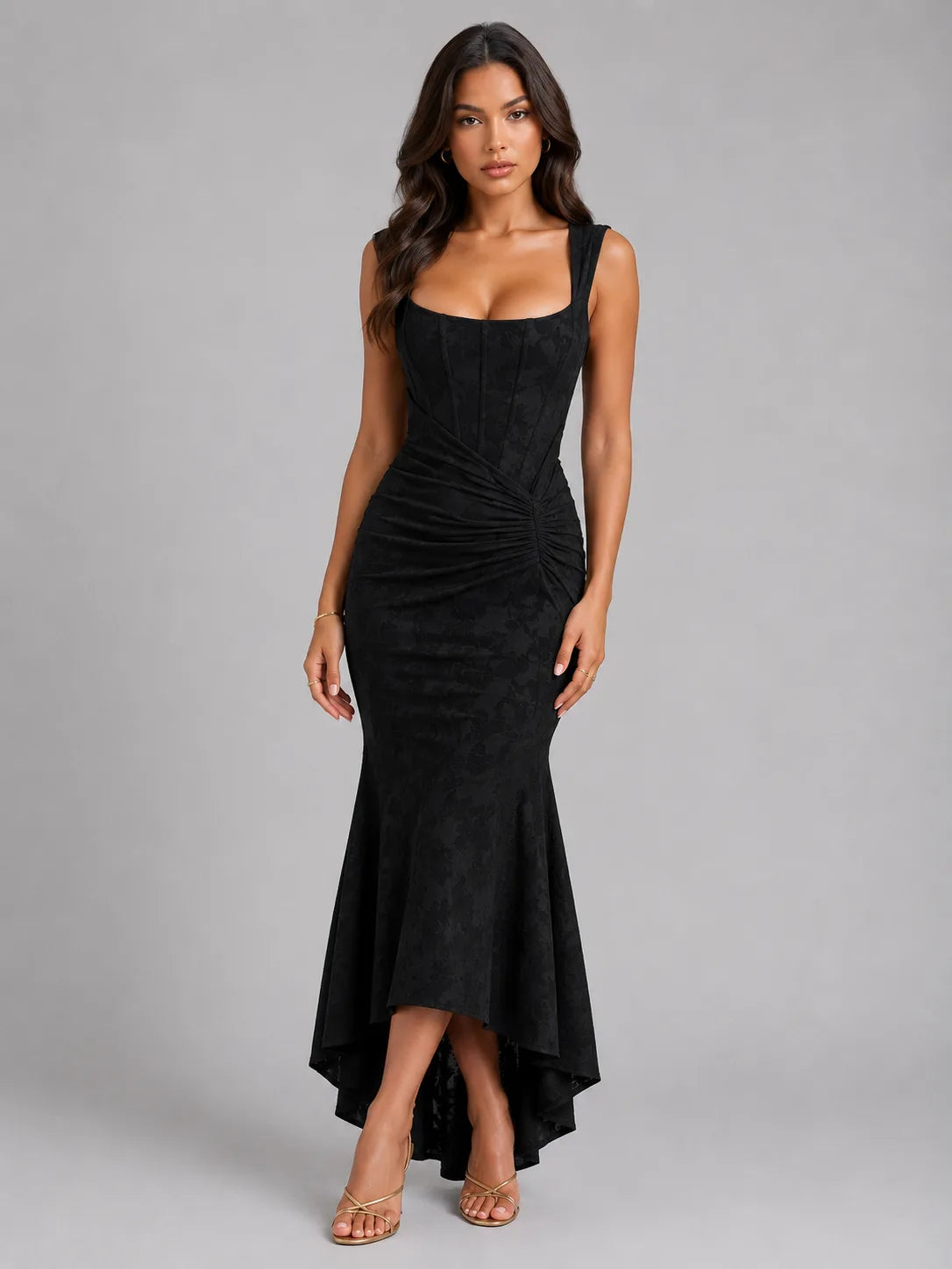 Front view of the same corset maxi dress in a black colourway styled with strappy heeled sandals