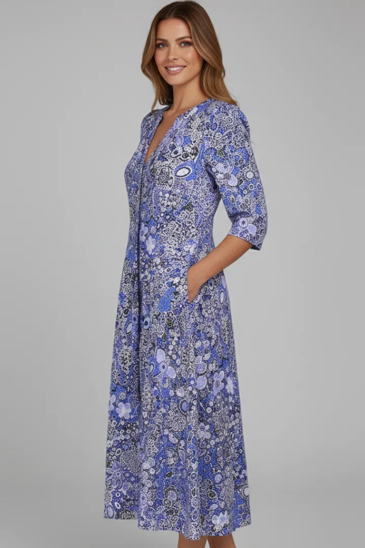 Side angle of the blue floral dress highlighting the three-quarter sleeve and front button placket