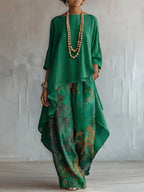 Front view of the green colourway, a boat-neck tunic top paired with floral print wide-leg pants and layered beads