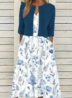 Navy cropped jacket over a white floral midi dress with flowing A-line skirt and pockets