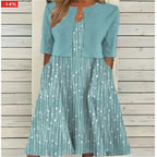 Teal two-piece midi dress with white dotted stripe print and matching cropped top, side pockets visible