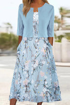 Pale blue floral midi dress with cropped jacket styled outdoors, showing relaxed fit and half sleeves
