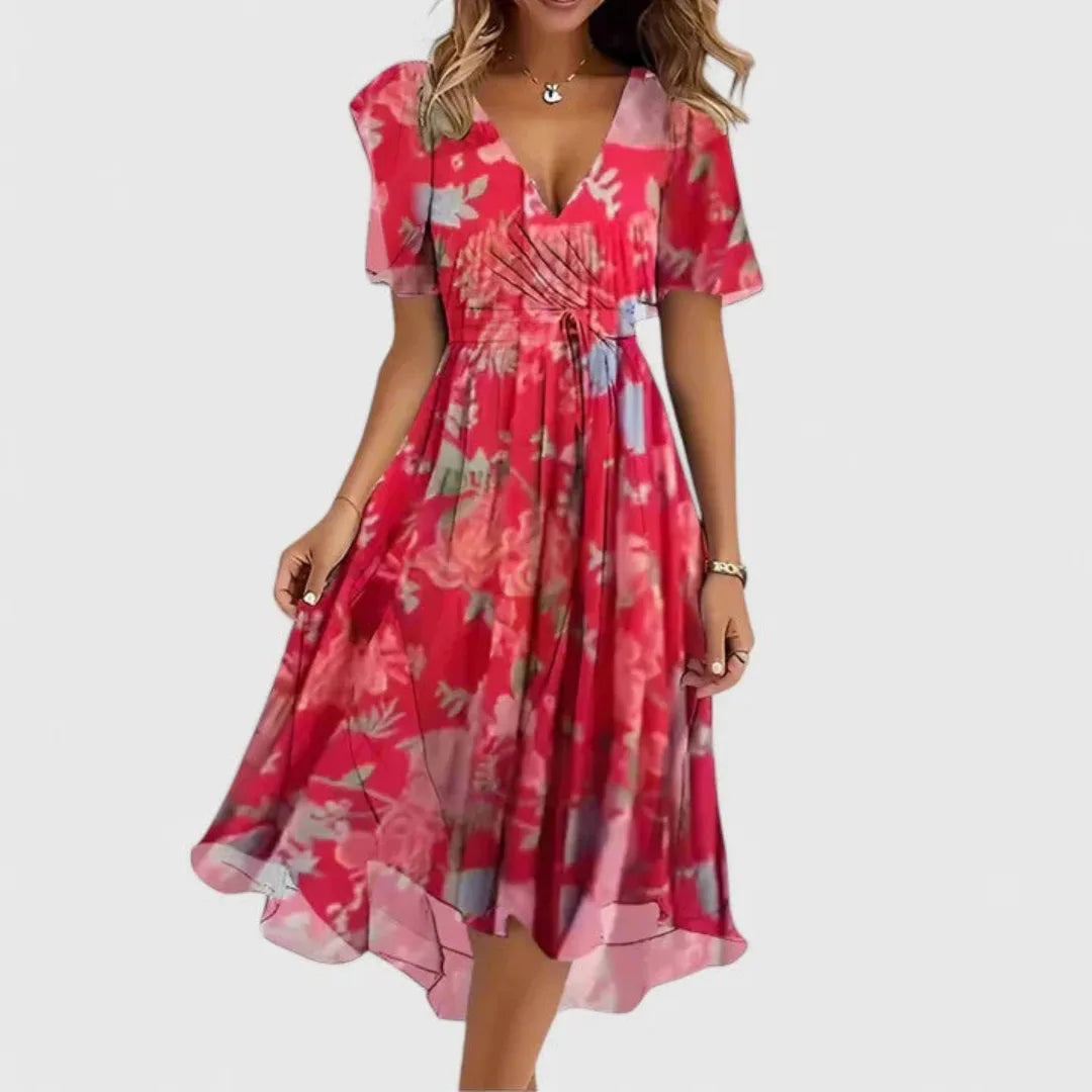 Model wearing a red floral chiffon midi dress with deep V-neckline, flutter sleeves and tie waist
