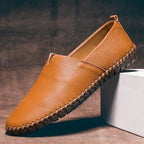Single phoenix brown leather loafer resting against a white block, showing tan insole