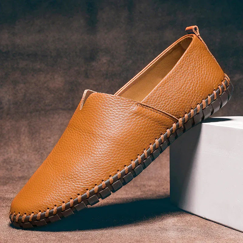 Single phoenix brown leather loafer resting against a white block, showing tan insole