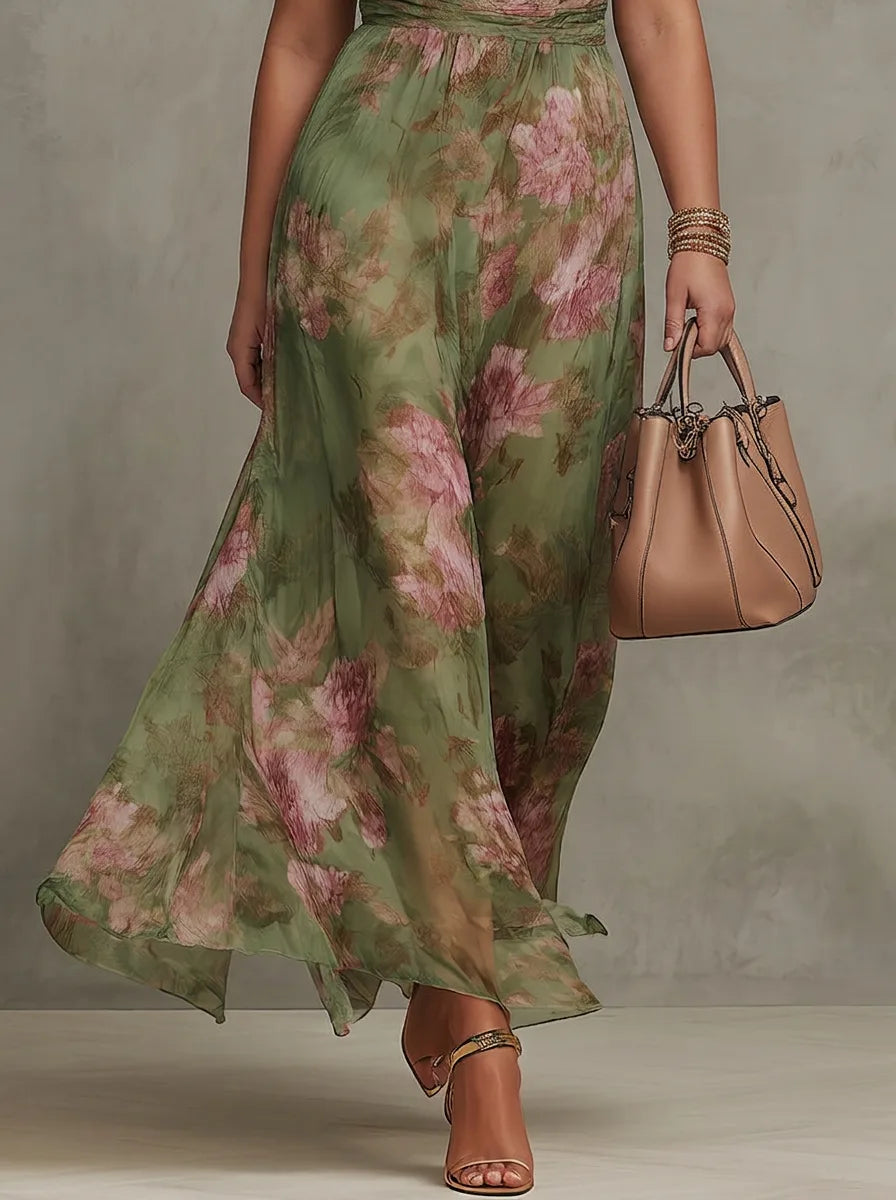 Close-up of the flowing chiffon maxi skirt in motion, showing the sheer floral print fabric and wrapped waist sash
