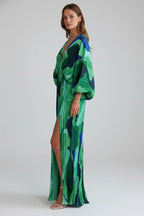 Side profile of the model highlighting the thigh-high side slit and billowing sleeve shape of the dress