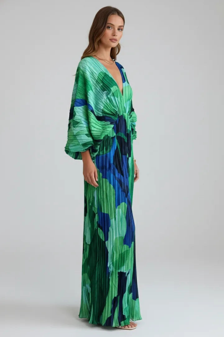 Three-quarter angle of the model showing the cinched waist and flowing pleated skirt of the maxi dress