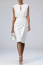 White sleeveless midi dress with round neckline keyhole cutout and soft side ruching, worn with a white top-handle handbag