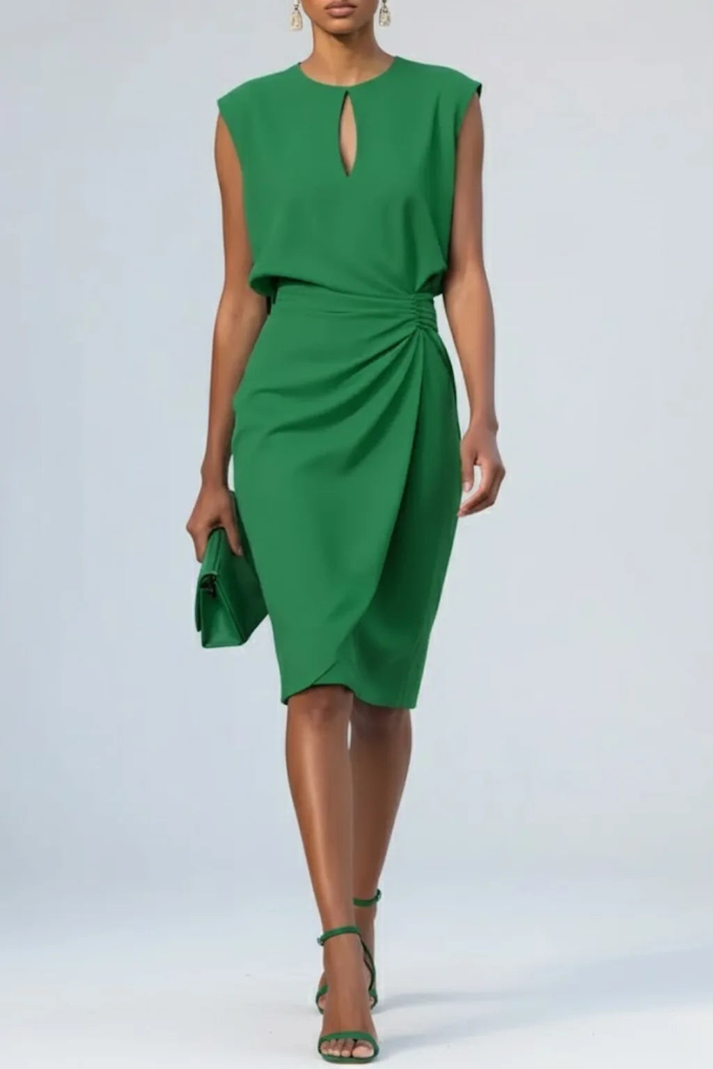 Green sleeveless midi dress showing the ruched waist drape and tulip-style hem, worn with matching green heels and clutch